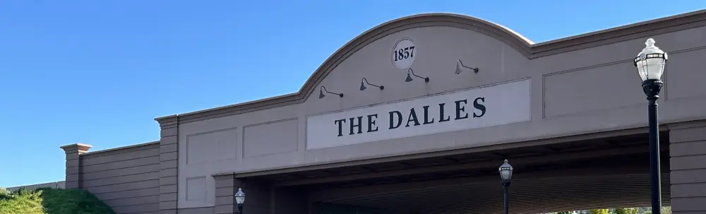 Entrance sign reading “The Dalles” with 1857 above it.