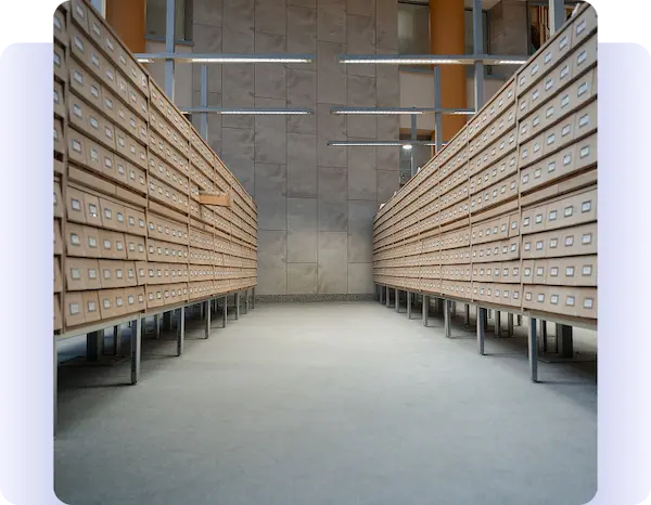 Aisle between long rows of labeled archival storage drawers.