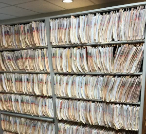 Rows of hanging paper or material samples on storage racks.