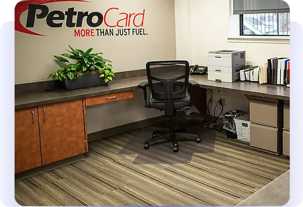 PetroCard office workstation with desk, chair, printer, and company logo.