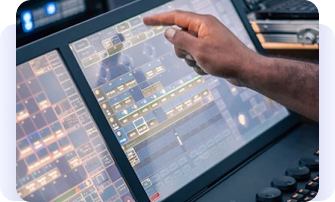 Person using a touchscreen control panel with technical interface displays.