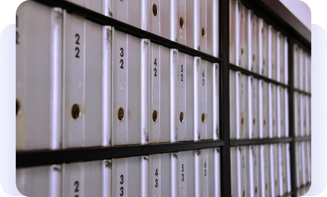 Close-up of numbered metal mailboxes.